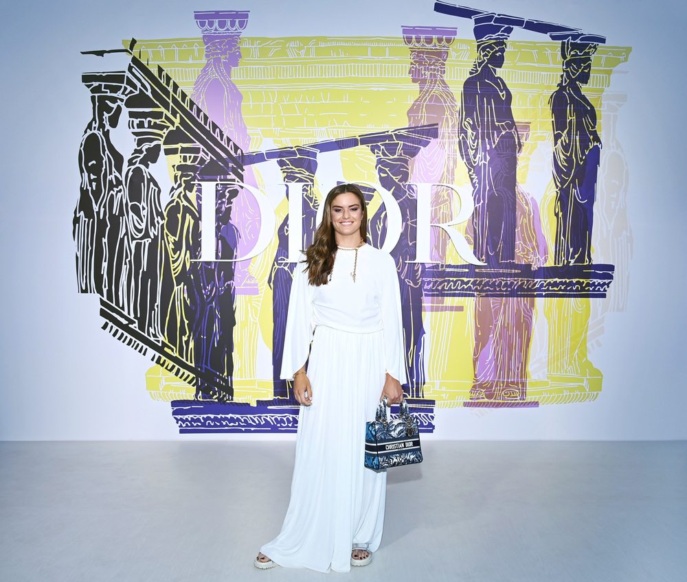Maria Sakkari wore a Dior white silk long dress with a small printed Book Tote bag and Dior sandals.