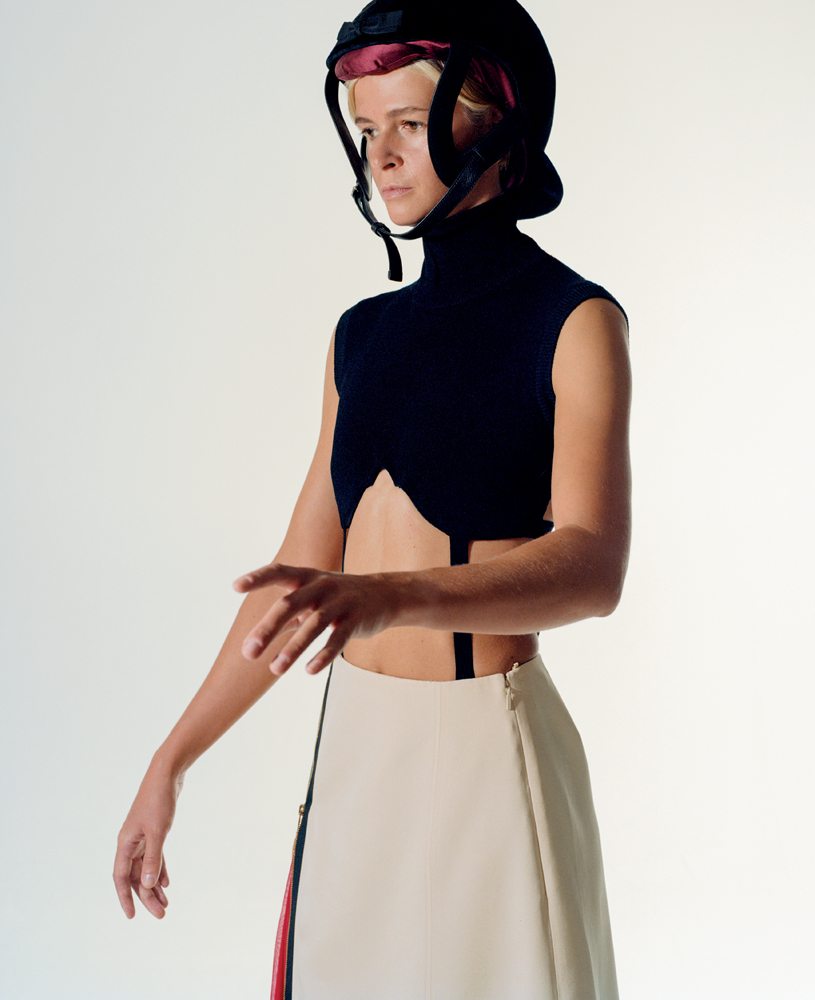 Sophie Varin wears a lycra top, a wool and silk skirt and a riding hat, GUCCI.