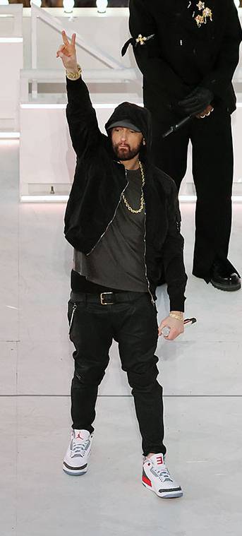 Eminem is wearing a custom pair of Air Jordan 3 sneakers, with the name tag “Slim Shady”.