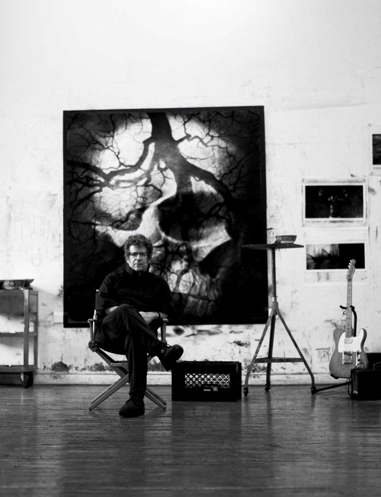 The theme of death continues through Robert Longo’s work, like the canvas he sits in front of in his studio. 