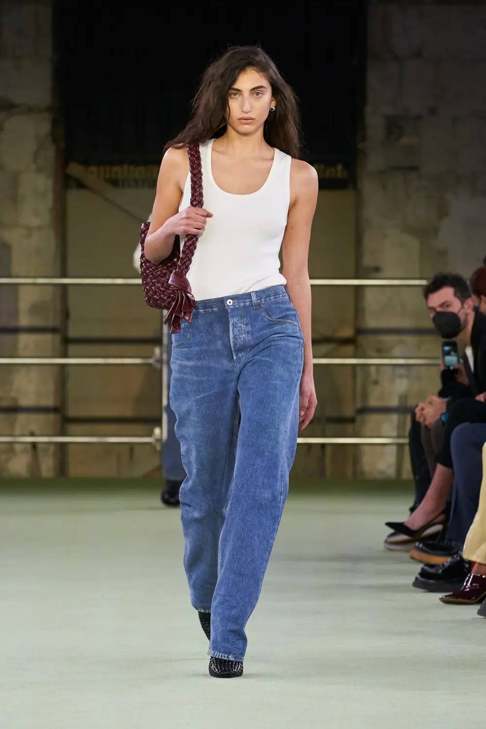 The first look from Matthieu Blazy’s first Bottega Veneta show with the denim printed leather trousers. 