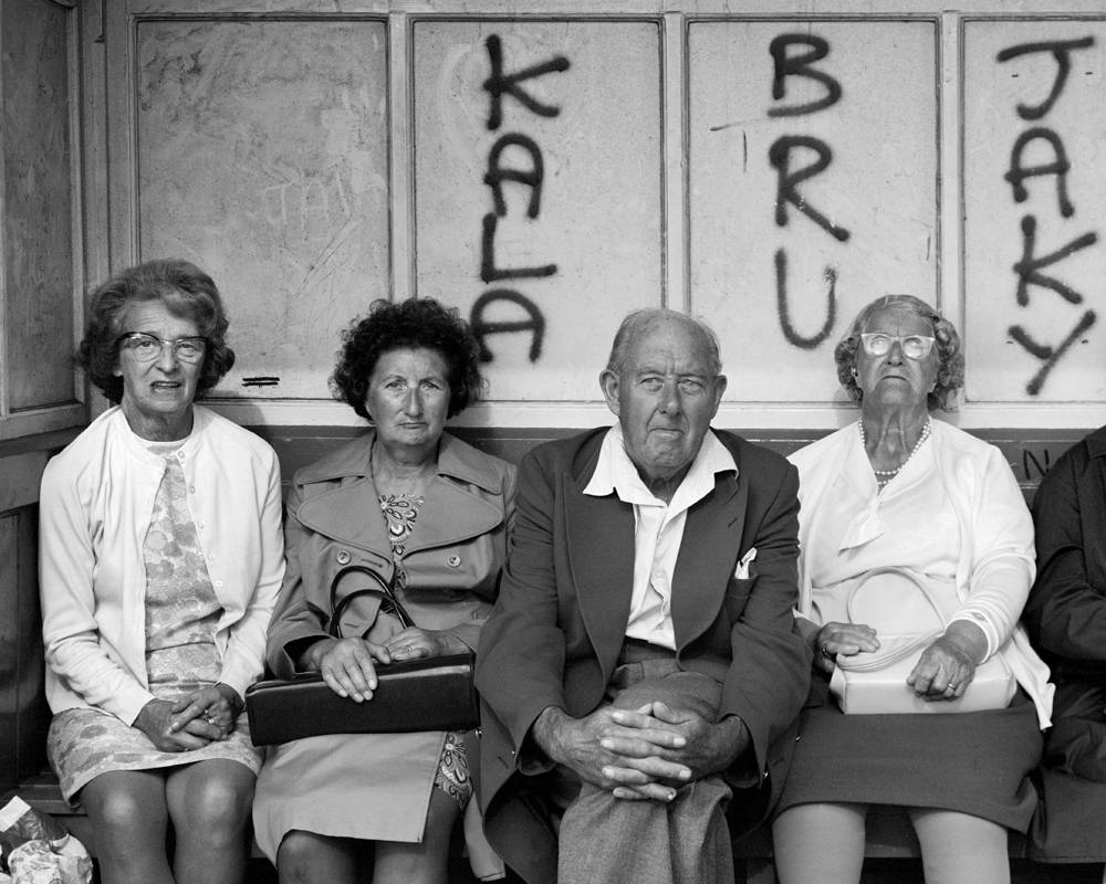 Four people in a shelter with graffiti. Whitley Bay, Tyneside, England, Great Britain, 1976 © Chris Killip Photography Trust/Magnum Photos