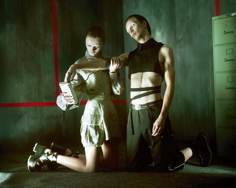 Her: top and short, FENDI. Boots, SACAI X PIERRE HARDY. Him: trouser, belt and socks, DIOR HOMME.Top, ANN DEMEULEMEESTER.