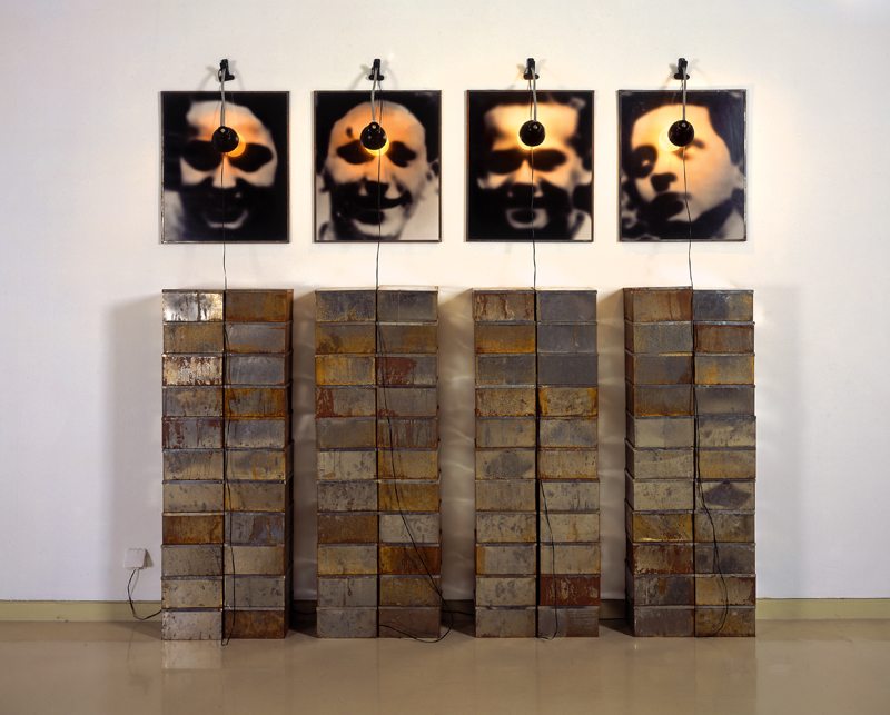 Christian Boltanski, Altar to the Chases High School (Autel Chases), 1987. 4 gelatin silver prints in metal frames, 88 tin boxes, 4 lamps, 223 x 238 cm overall. Gift of Shawn and Peter Leibowitz to American Friends of the Israel Museum, in memory of Charles and Rosalind Leibowitz and Leila Sharenow © The Israel Museum by Meidad Suchowolski.
