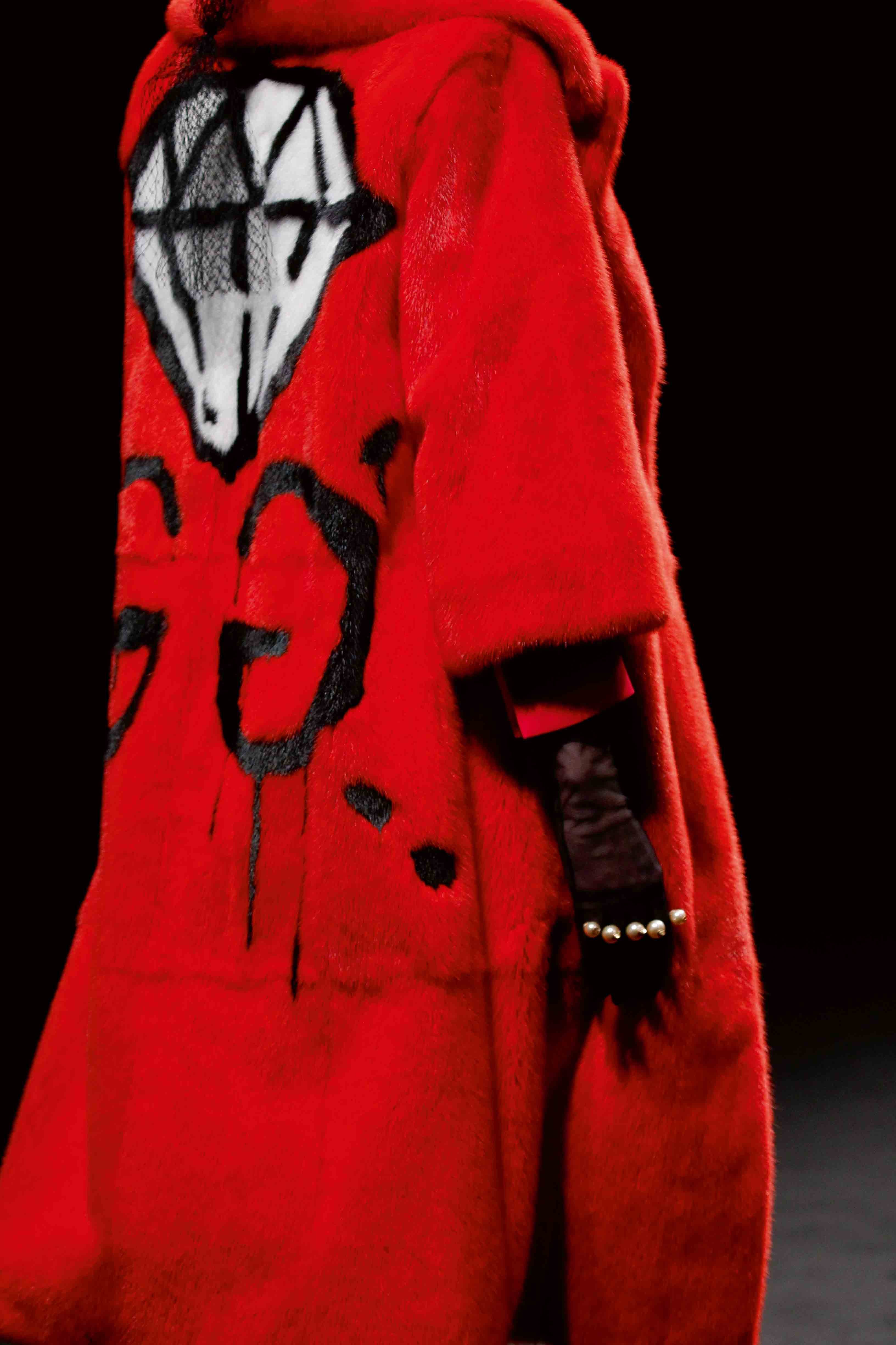 Iconique manteau rouge griffé d’un double G signé de l’artiste GucciGhost, alias Trevor Andrew.