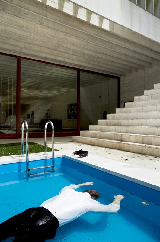 "Death of a Collector" (2009). Swimming Pool, Silicone Mannequin, Rolex Watch, Marlboro Cigarette Pack, Clothes and Shoes, 100 x 600 x 200 cm. This work was presented at the Venice Biennale in 2009.