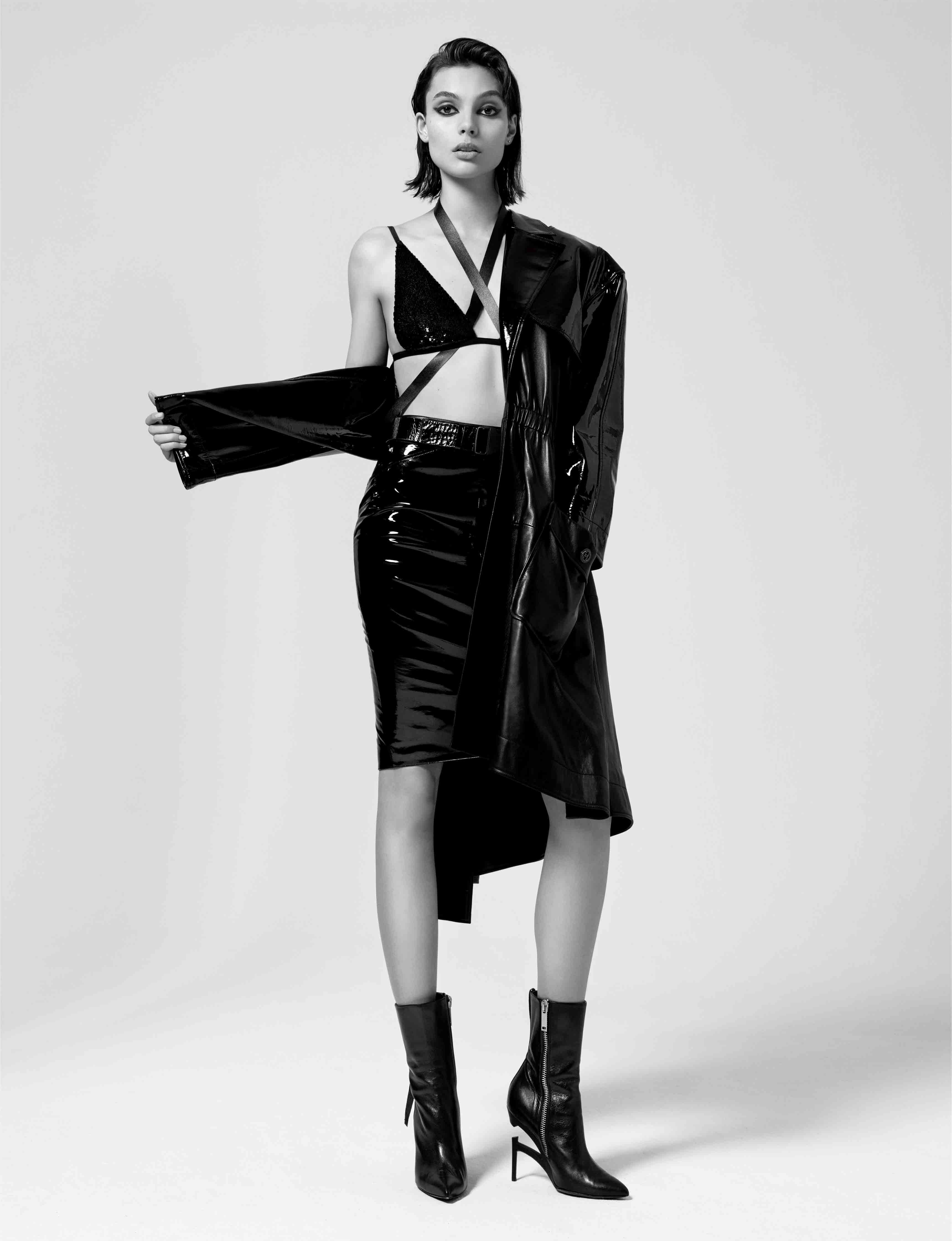 Patent leather trench coat and skirt, CHANEL. Bra, ALTUZARRA. Leather straps, MOKUBA. Boots, UNRAVEL.