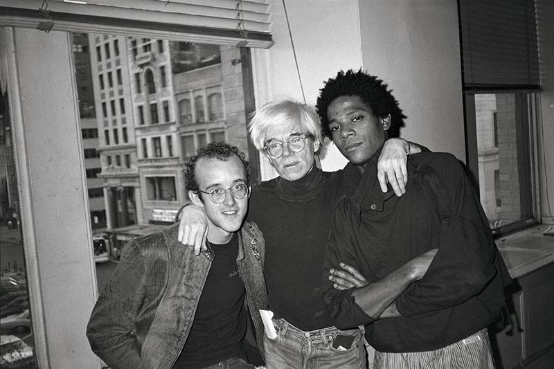“Keith Haring, Andy Warhol and Jean Michel at Andy’s studio at 860 Broadway, April 23, 1984” © The Andy Warhol Foundation for the Visual Arts, Inc.