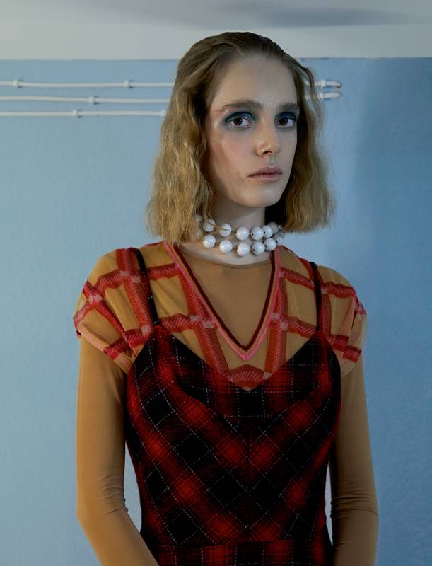<p>Sleeveless tweed dress and checkered Nylon T-shirt, MIU MIU. Necklace, BALENCIAGA. Body, REPETTO.</p>
