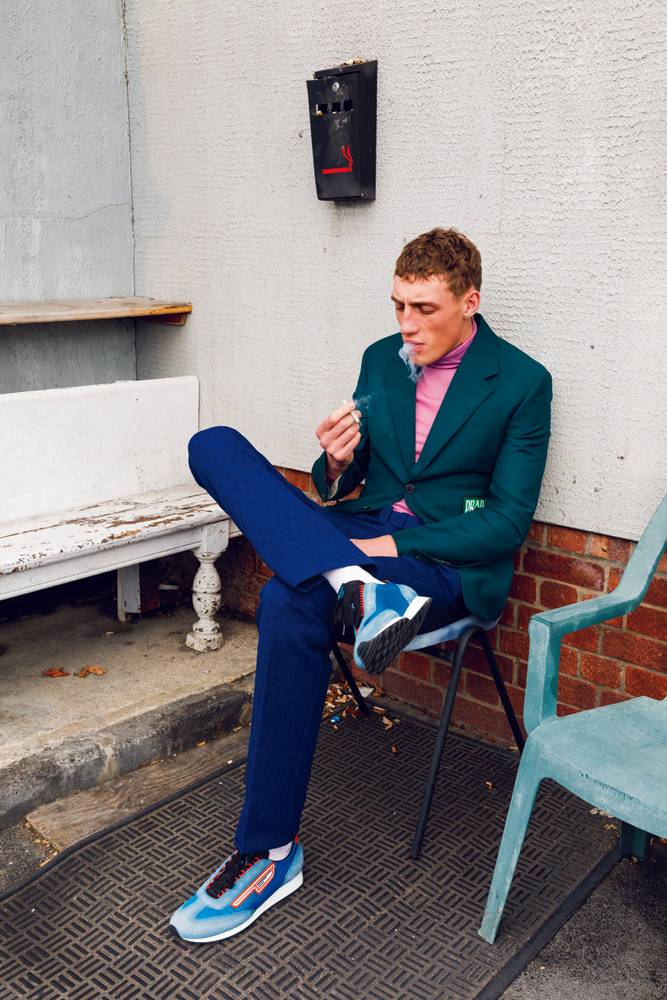 <p>Jacket and trousers, polyester sweater and sneakers, <strong>Prada. </strong>Socks, <strong>Falke.</strong></p>
