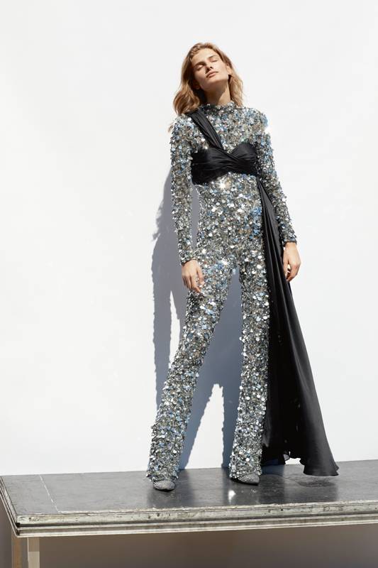 <p>Fully embroidered sequins jumpsuit and chiffon bodice, MOSCHINO. Ankle boots, GIUSEPPE ZANOTTI.</p>

